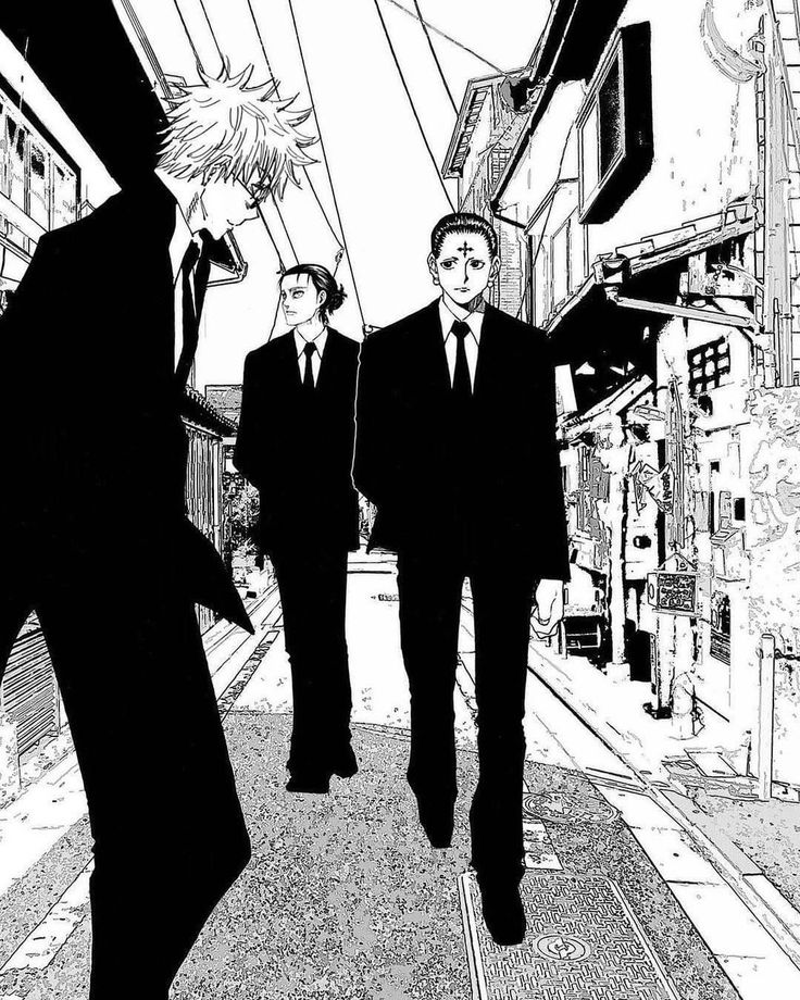 two men in suits are walking down the street