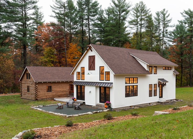 a large white house sitting in the middle of a forest