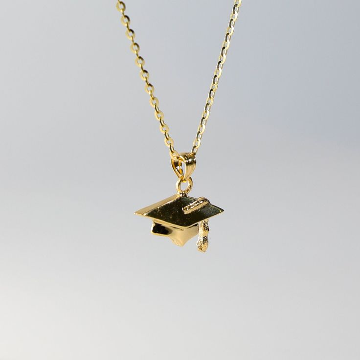 Congratulations on your graduation! Wear this commemorative necklace, it's a celebration! This 14k gold Graduation Hat Pendant features a traditional graduation cap with intricate detailing including a tassel hanging from the center of the hat. A graduation hat represents the academic tradition and accomplishment of graduation while the gold further emphasizes the value and significance of this accomplishment. A 14k gold necklace with pendant such as this gold graduation pendant is the perfect c Elegant Gold Jewelry For Graduation, Adjustable Jewelry For Graduation Gifts, Luxury Gold Plated Pendant Charms, Graduation Money Necklace, Personalized Gold Necklace For Graduation Gift, Yellow Gold Dangling Charms Necklace, Gold Plated, Graduation Necklace, Graduation Hat, 14k Gold Necklace