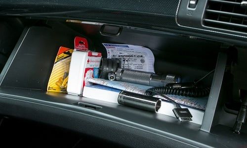 the interior of a car with various items in it and an air freshener dispenser