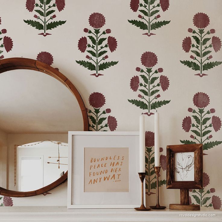 a mirror and some flowers on a mantle