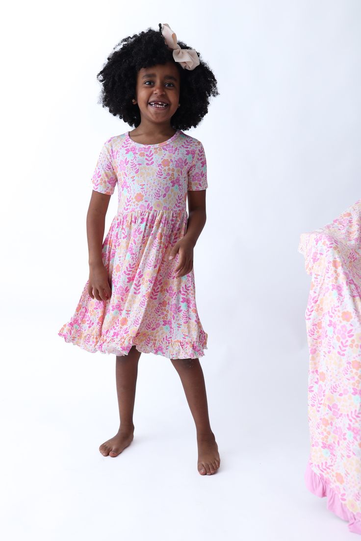 Twirl into a garden of dreams with our Garden Treasures Dream Ruffle Dress. Featuring short sleeves and a beautiful floral design, this dress is sure to add a touch of fun to your wardrobe. Perfect for twirling around and making unforgettable memories! Made from the softest and most breathable seasonal bamboo viscose material, your babe won't want to take this off! Designed for all the love and extra play! Tuxedo Accessories, Girls Gloves, Girls Dress Outfits, Toddler Flower Girl Dresses, Bodysuit Dress, Baby Christmas Outfit, Wedding Dress Shoes, Birthday Party Dress, Unforgettable Memories