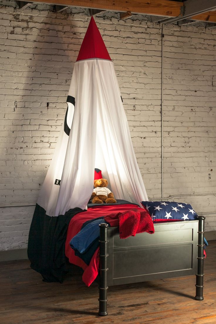 a bed with a red, white and blue canopy hanging from it's side