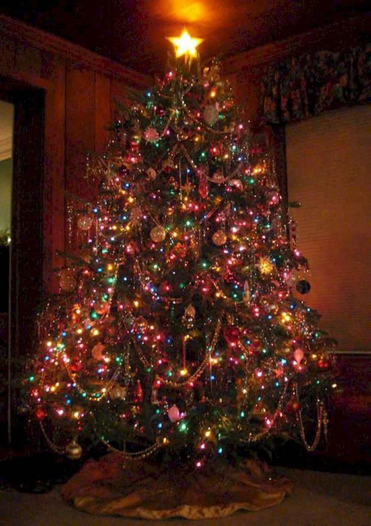 a brightly lit christmas tree in a living room