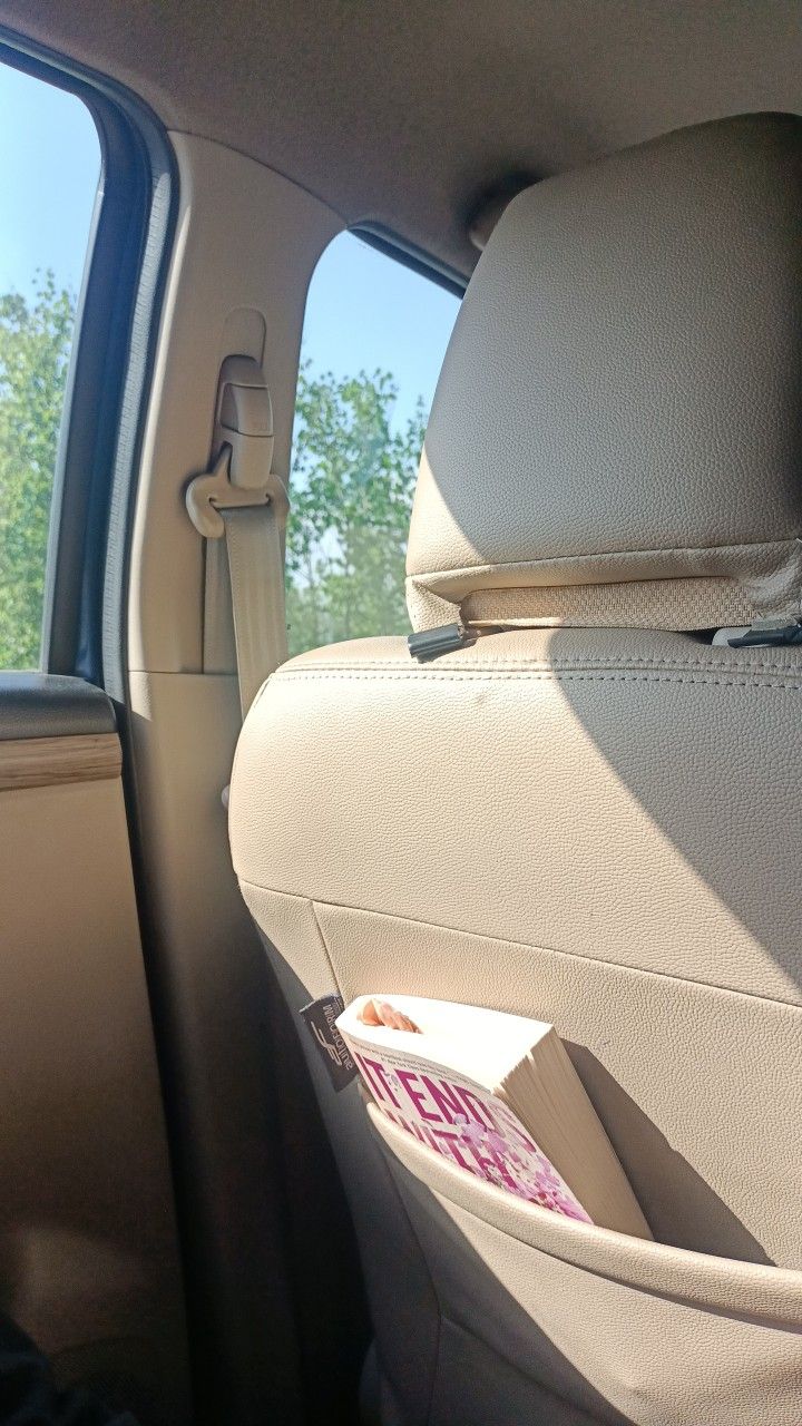 the back seat of a car with an open book in it's pocket,