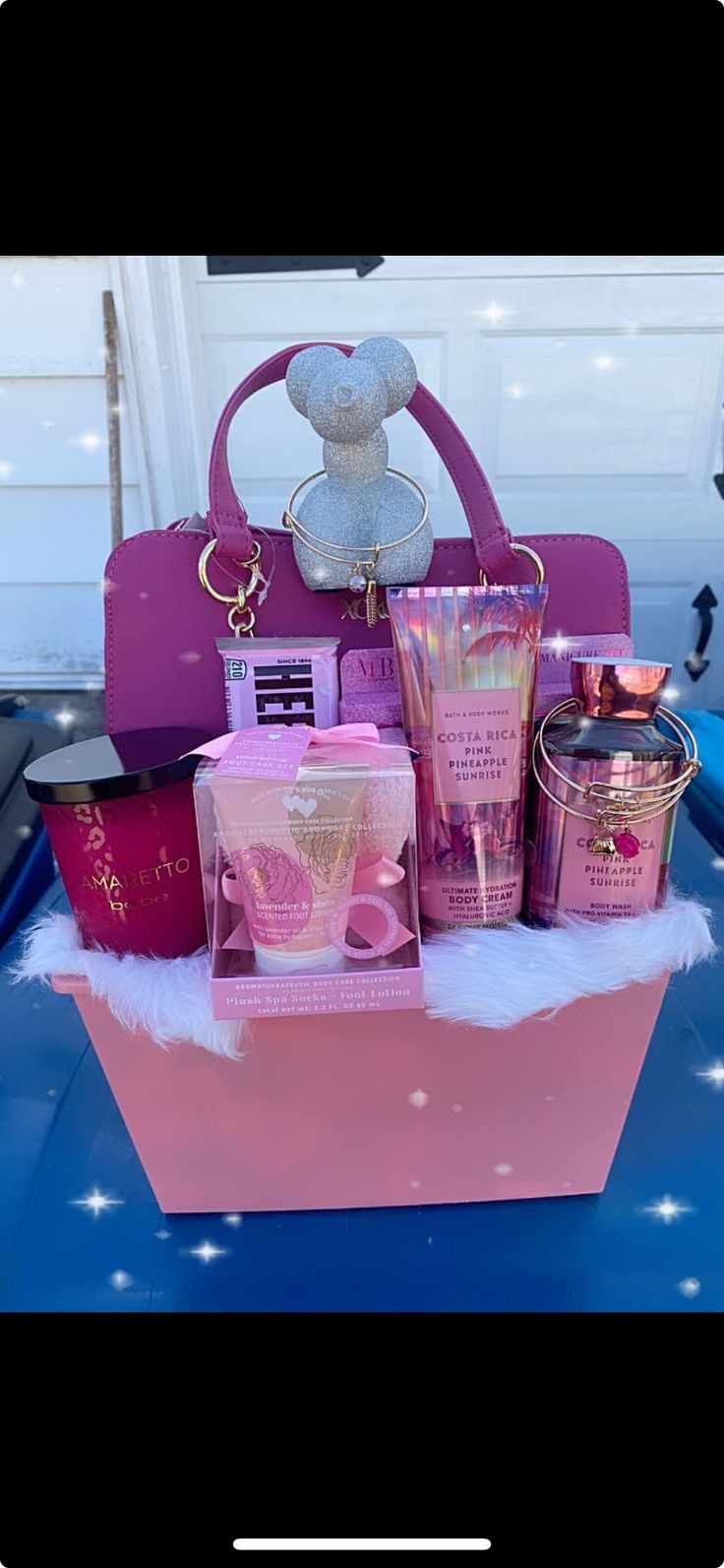 a pink box filled with lots of different types of items on top of a blue table