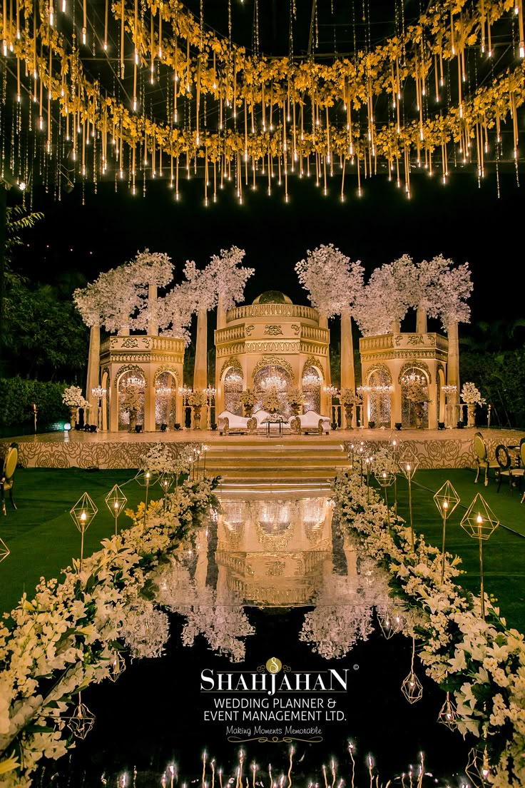 an outdoor wedding venue with white flowers and chandeliers