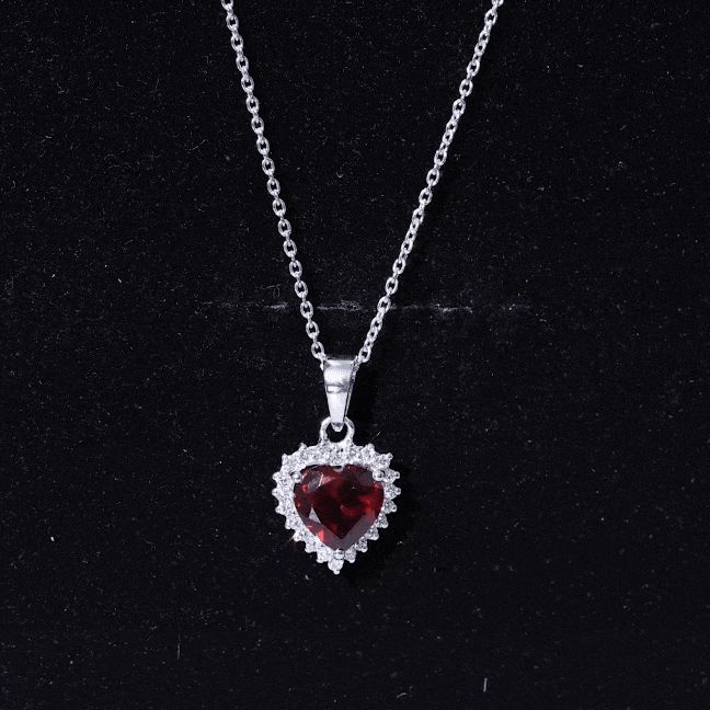 Product Details This lovely Heart Pendant Necklace is sure to capture the heart of any recipient. The Heart Shape Garnet Gemstone is surrounded by a sparkling halo of Moissanite Gemstones, creating a striking contrast against the gleaming silver setting. Whether its a romantic gesture or a special gift for a loved one, this Pendant Necklace is a timeless piece that will be treasured for years to come. Product Information SKU SHP-PENDANT092022186 Weight 3.39 gm (Approximate) Center Stone Weight 4 Garnet Heart, Necklace With Diamond, Romantic Gestures, Garnet Necklace, Garnet Gemstone, Diamond Halo, Heart Pendant Necklace, Diamond Gemstone, Halo Diamond