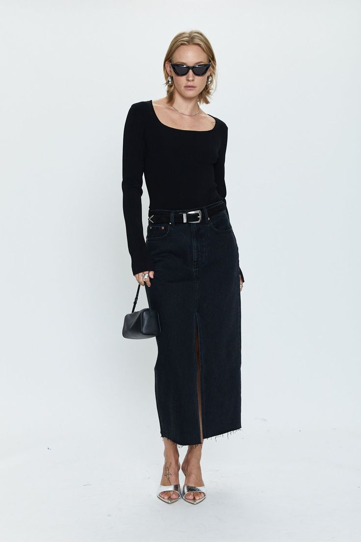 Of-the-moment, yet eternally stylish - our best selling skirt features an elongated midi length and five pocket denim design notes. Crafted from rigid denim without stretch for sophisticated fit and fall, with a well considered front skirt slit for¬†ease of movement. Offered in a dark black wash with frayed hem detail. 100% Cotton Imported Black Denim Midi Skirt Outfit, Long Black Denim Skirt Outfit, Black Leather Midi Skirt, Black Denim Skirt Outfit, Black Denim Midi Skirt, Black Vacation, Street Style Skirt, Holy Girl, Comfort Fashion