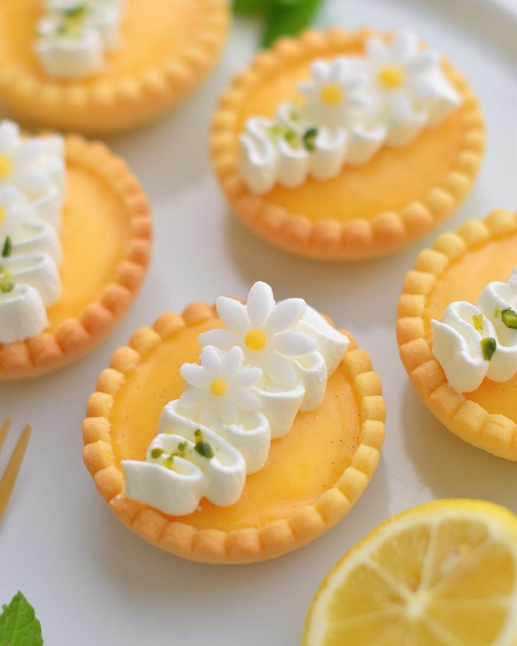 lemon tarts decorated with white flowers and daisies