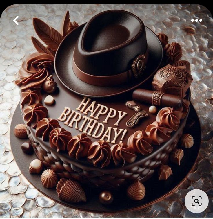 a birthday cake with chocolate decorations and a hat on top