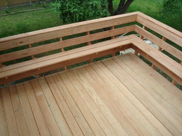 a wooden bench sitting on top of a wooden deck