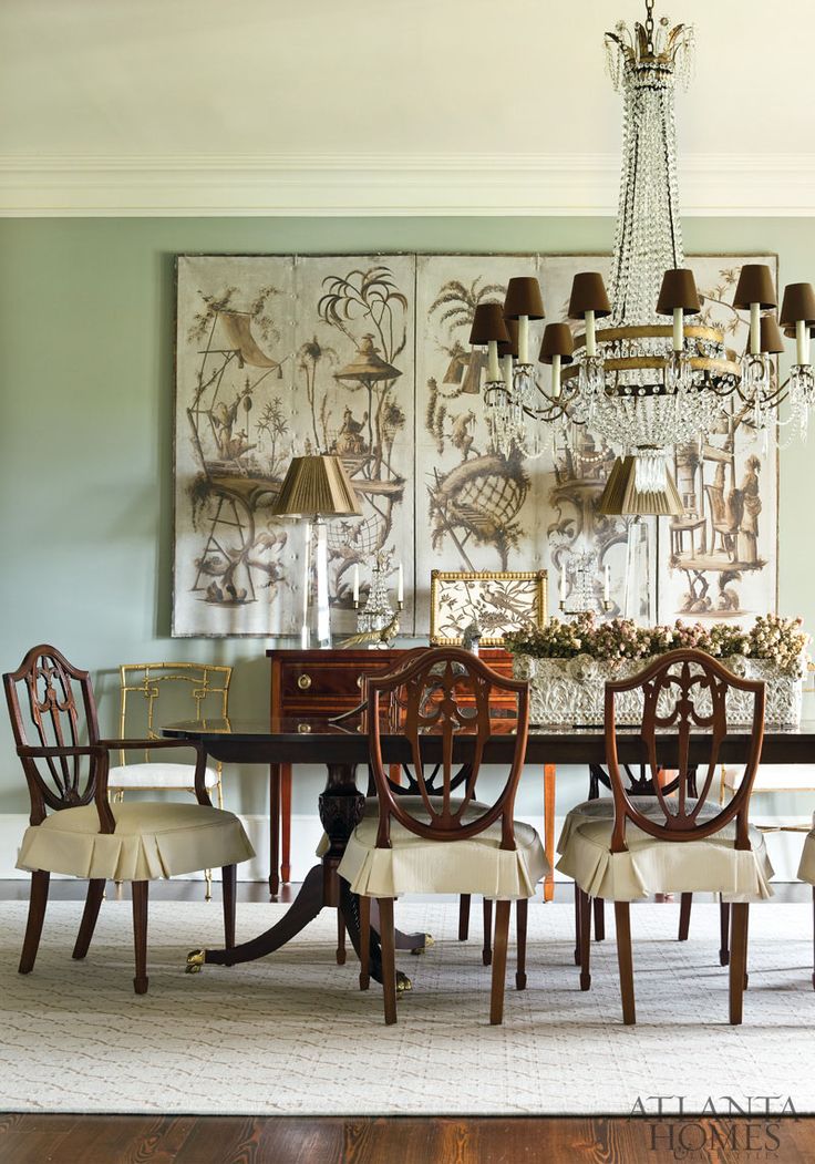 a dining room table with chairs and a chandelier