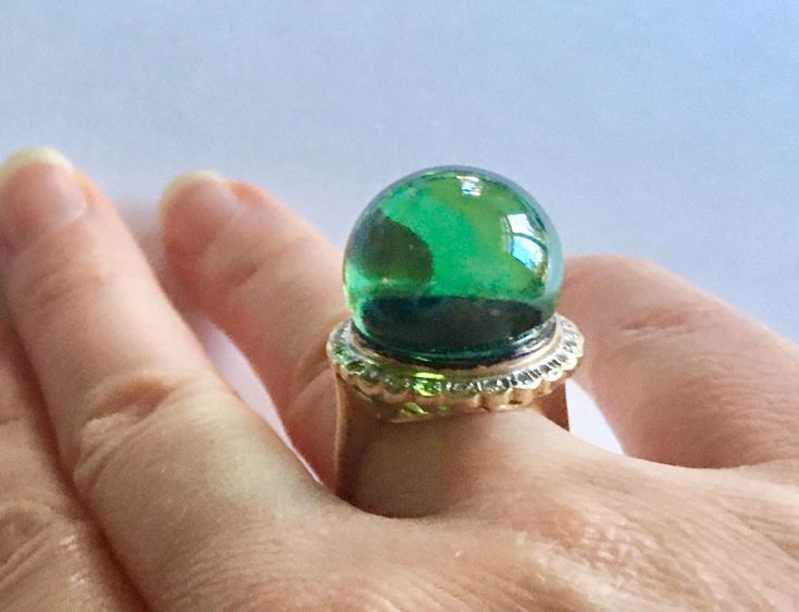 Beautiful rare large ring made in solid 14k gold with diamonds halo! Set with a large glass ball orb/similar to antique pools of lights. The orb is green in color. Size is 6-6.2USA Weight is approx 10.87g Size of the orb approx 16.4mm at the widest and 12.8mm is raised above the setting the face of the ring approx 19.5mm Diamonds are 1mm each approx Gold is solid yellow 14k hallmarked and tested. Light age patina, in great vintage condition. No cracks, no nicks no damages. Clean beautiful item! Elegant Domed Emerald Ring, Luxury Green Domed Ring, 14k Gold Green Gemstone Dome Ring, Elegant Green Domed Jewelry, Elegant Green Dome Ring, Green Cabochon Dome Ring For Formal Occasions, Formal Green 14k Gold Dome Ring, Green Dome Ring For Anniversary In Fine Jewelry Style, Green Dome Ring For Anniversary, Fine Jewelry