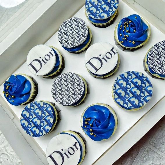 a dozen decorated cookies in a box with the word diot written on one side