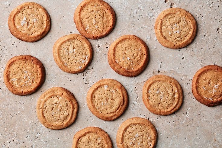 twelve cookies on a baking sheet ready to be baked