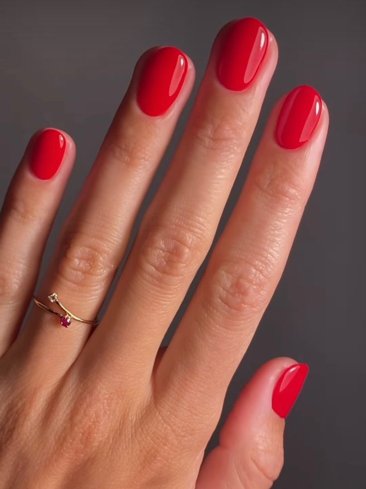 Short round nails painted red Shellac Round Nails, Short Rounded Nails Gel, Short Oval Nails Color, Red Nails Simple Short, Gel Nails Red Short, Gel Mani Short Nails Red, Candy Red Nails Short, Oval Short Red Nails, Short Red Sns Nails