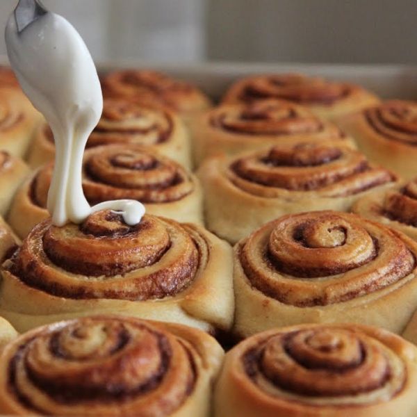 there is a small white bird on top of some cinnamon rolls