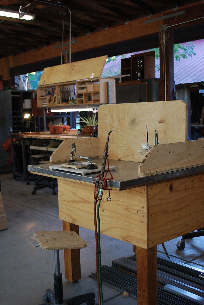 the workbench is being worked on by someone in their garage or workshop with woodworking tools