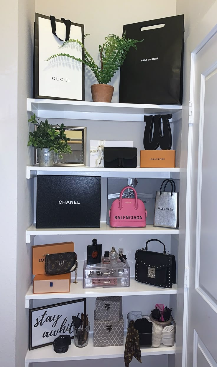 a white book shelf filled with purses and bags