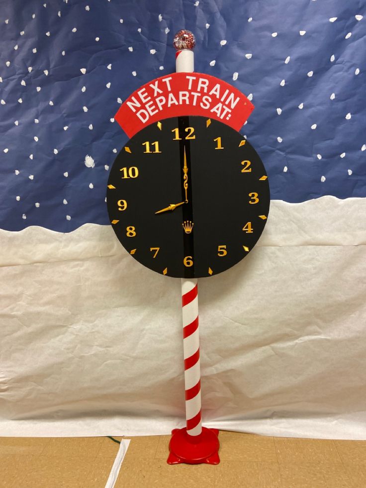 a clock with a candy cane sticking out of it