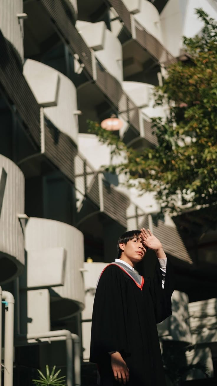 a man standing in front of a tall building