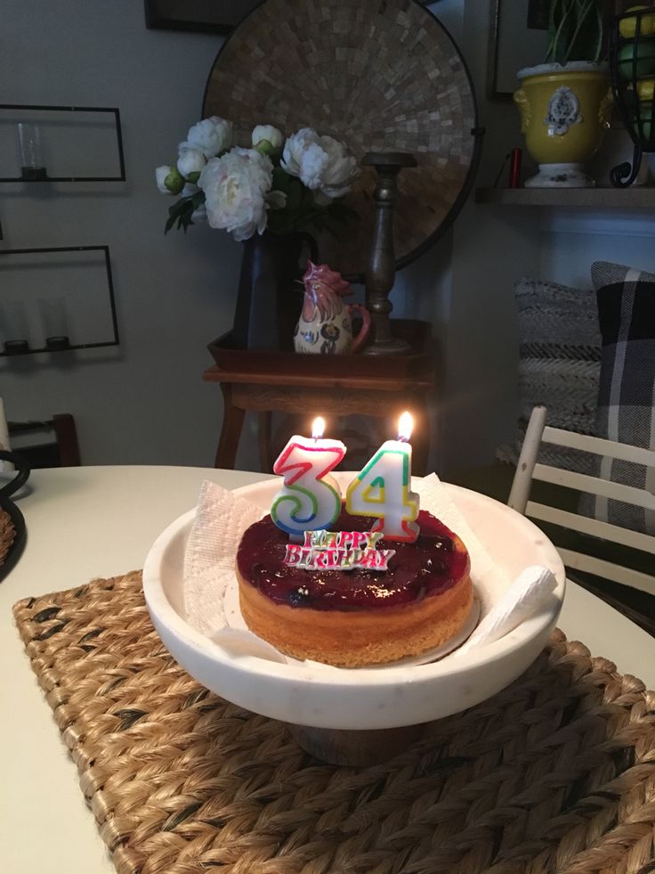 a birthday cake sitting on top of a table with candles in the shape of 54