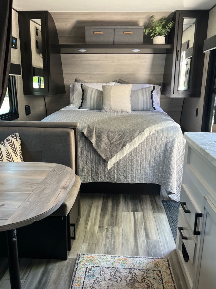 a bed sitting in the middle of a bedroom next to a table