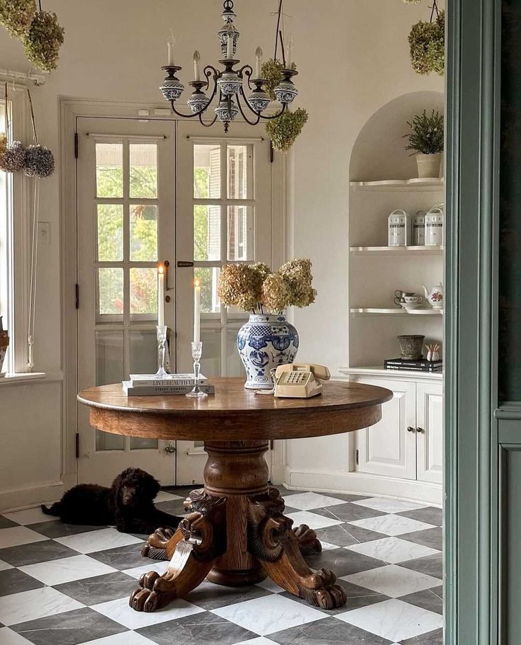 a dining room with a checkered floor and chandelier