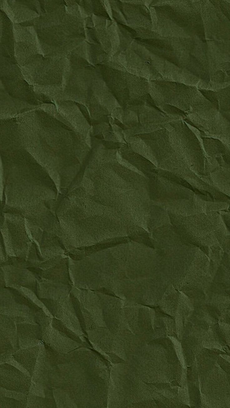 an old paper textured with dark green color is seen in this image, it appears to be crinkled