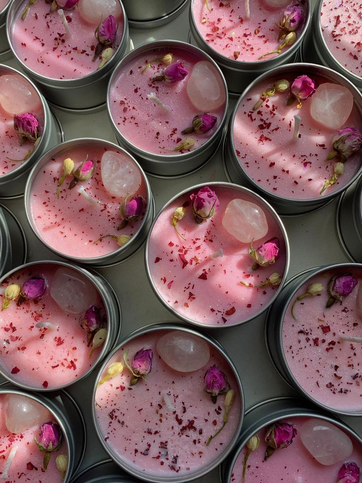 several tins filled with different types of food and flowers on top of each other