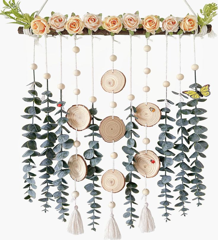 a wind chime with flowers and leaves hanging from it