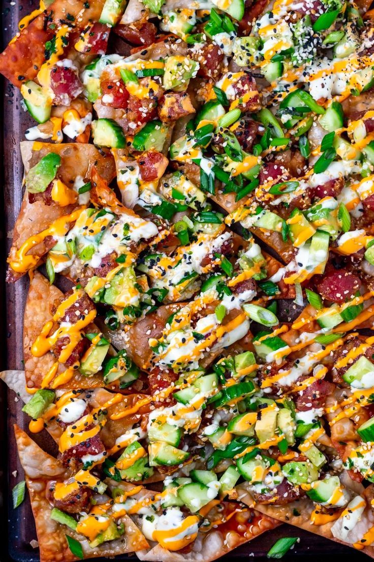 a pizza topped with lots of toppings on top of a metal baking pan,