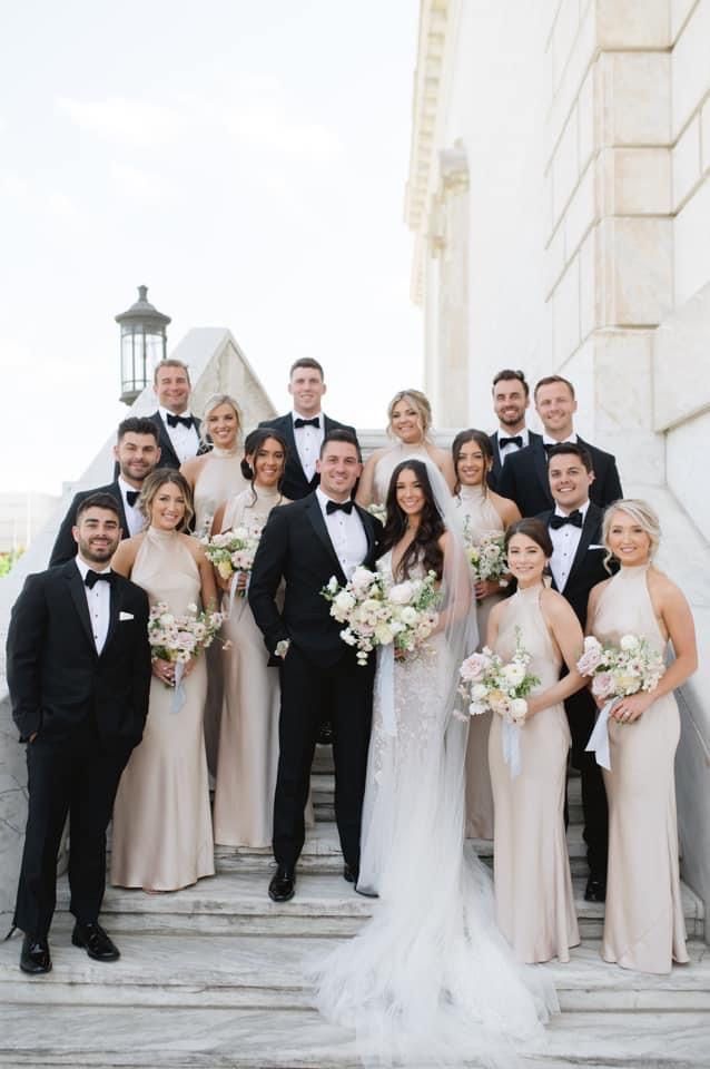 a group of people in formal wear standing on steps