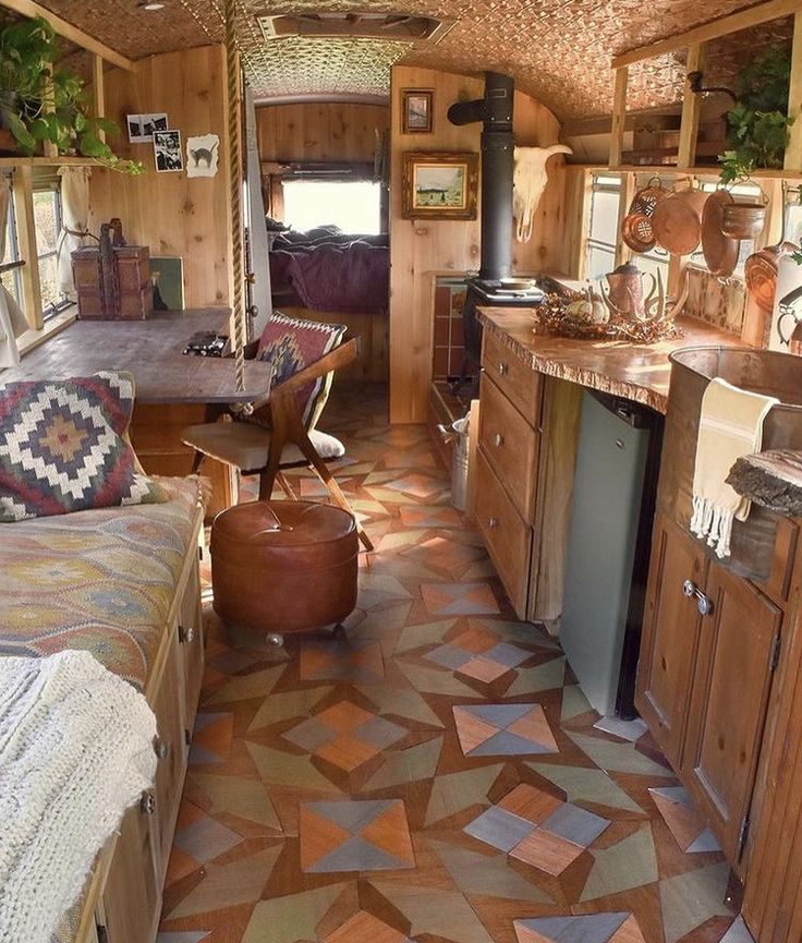 the interior of an old fashioned camper with wood paneling and tile flooring