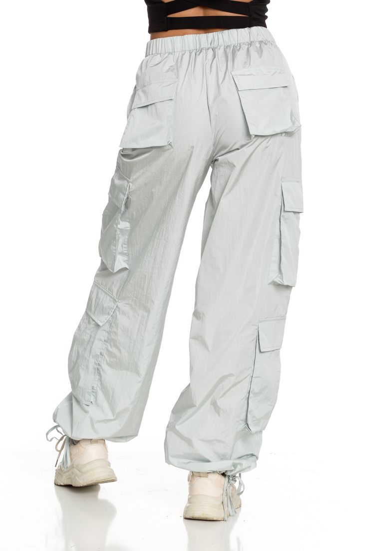 NEW Limited Edition & custom designed Ice Grey Parachute Pants! Not only did we spend months designing these amazing cargo style pants, but we PERFECTED them in the process! These pants are insanely versatile due to their lightweight material and trendy style. They feature adjustable ankle cuffs that you can leave wide or tie up for a jogger look. The elastic waist-band allows for a comfortable fit and the multiple pockets provide great functionality. These pants easily can be worn for any worko Grey Parachute Pants, High-waisted Parachute Pants With Drawstring, Sporty Moisture-wicking Parachute Pants, Full-length Nylon Parachute Pants With Side Pockets, High-waisted Khaki Parachute Pants With Elastic Waistband, White High-waisted Parachute Pants With Elastic Waistband, Athletic Top, Tennis Skirts, Cargo Style