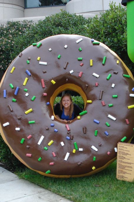 a giant donut with chocolate frosting and sprinkles is on display