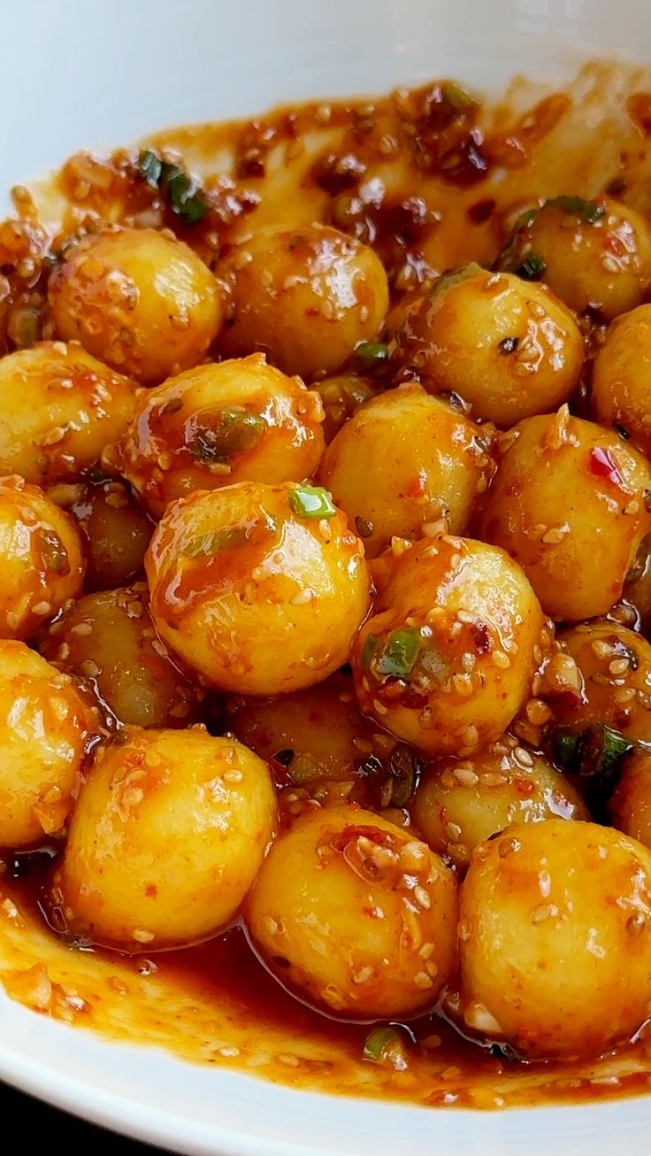 a white bowl filled with cooked food on top of a table