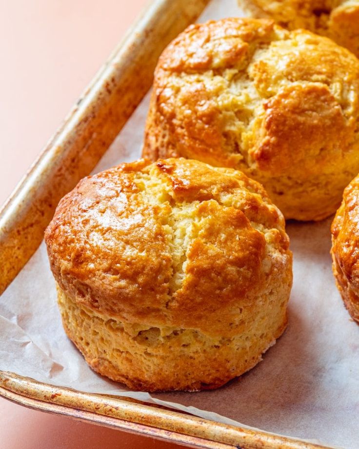 freshly baked muffins sitting on top of a pan