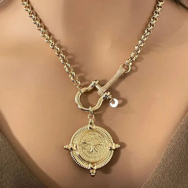 The French Bee Pendant necklace features a beautifully detailed gold plated Bee medallion and a screw horse shackle with a CZ connector. Both are 18k gold plated and are attached to a high-quality 18k Plated Rolo chain. This is a beautiful, elegant necklace. Ideal to wear with a chocker for a layering effect. Tips to keep your jewelry looking good. 1) Keep jewelry away from water and chemicals. 2) Remove during physical activities. 3) Store separately in a soft pouch or airtight box. 4) Avoid we Chunky Jewelry Necklace, Clean Fast, Equestrian Jewelry, Beautiful Gold Necklaces, 18k Gold Necklace, Bee Pendant, Gold Bee, Chunky Jewelry, Cable Sweater