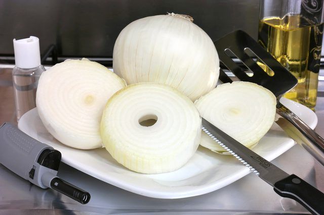 onions are cut up on a plate with a knife