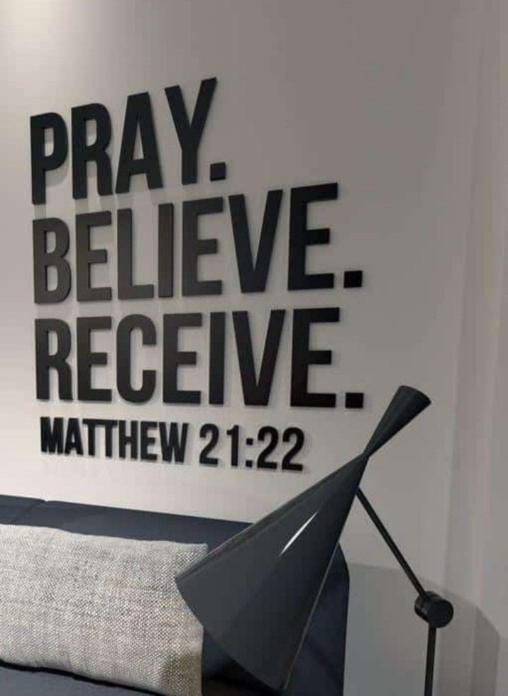 a black and white photo of a bed with the words pray, believe, receive