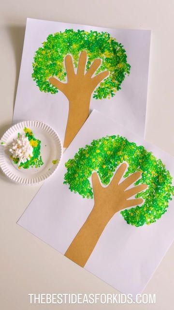 two paper plates with trees on them next to a white plate filled with green food