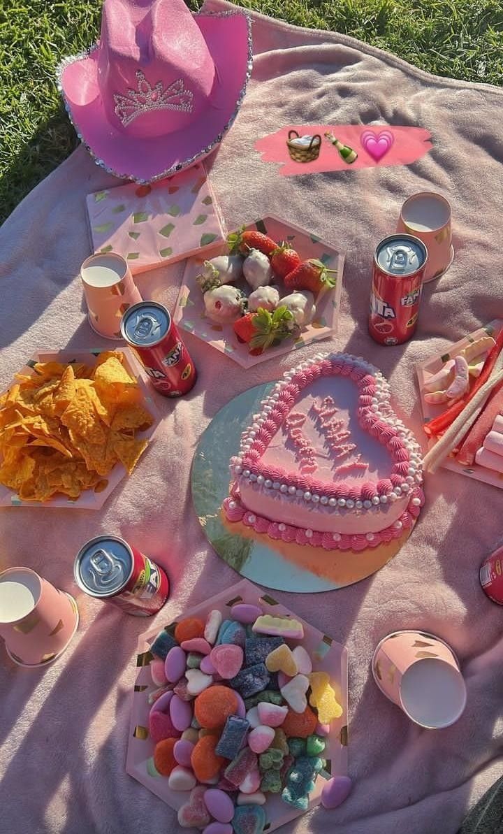 a picnic blanket with food and drinks on it