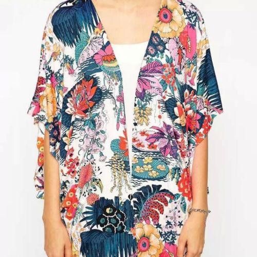 Extremely comfortable loose polyester open blouse.Wear it over a tank top and get all the attention. V-neck Rayon Top For The Beach, Versatile V-neck Blouse For Beach, Beachwear V-neck Tops With Tropical Print, Summer Rayon Blouse With Floral Print, Casual Rayon Blouse For Beach, Versatile Summer Rayon Tops, Flowy White Top For Beach Cover-up, Vacation Rayon Blouse With Floral Print, Floral Print Rayon Blouse For Vacation