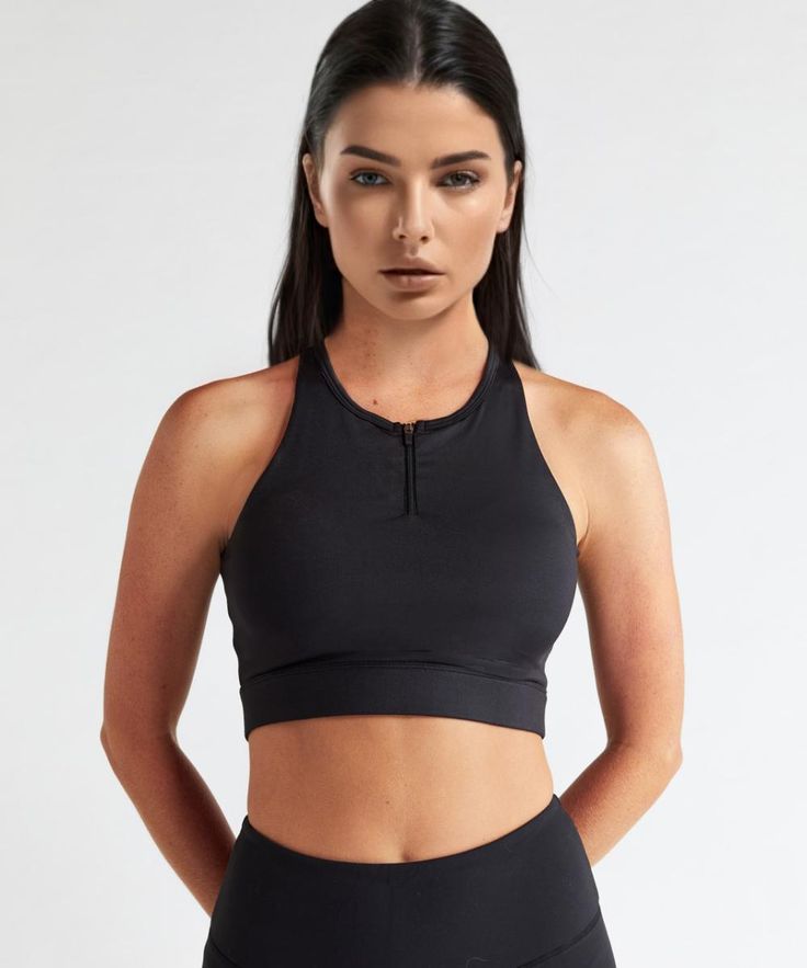 Experience the luxury of our soft performance sports bra with a high neck zipper front and opened back for a sexy silhouette. Our crop length bra has removable cups and is designed for high-to-low impact workouts. FEATURES: 4-way stretch technical fabric, breathable, and moisture wicking Trimmed front neckline Extra-wide straps for added support Wireless, molded, seam-free, removable cups Front lock zipper Front cell phone pocket consists of layered mesh paneling and proprietary shielding, which Set Active, Low Impact Workout, Black Sports Bra, Sport Bra, Wide Straps, Black Media, Front Zipper, Basic Tank Top, Moisture Wicking