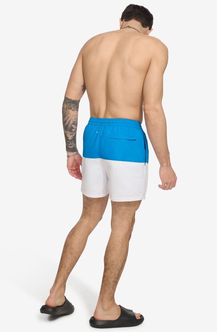 Soak up the sun in these cool colorblocked swim trunks built from quick-drying fabric. 5" inseam (size Medium) Elastic/drawstring waist Front slant pockets; back patch pocket Lined 100% polyester Machine wash, tumble dry Imported Blue Nylon Athletic Shorts For Beach, Blue Beachwear Athletic Shorts For Pool, Nylon Swim Trunks For Poolside, Nylon Swim Trunks For Poolside And Beach Season, Beach Season Nylon Swim Trunks For Poolside, Nylon Swim Trunks For Beach, Nylon Short Length Swim Trunks For Beach, Nylon Beachwear Athletic Shorts For Beach Season, Sporty Swim Trunks For Beach Season