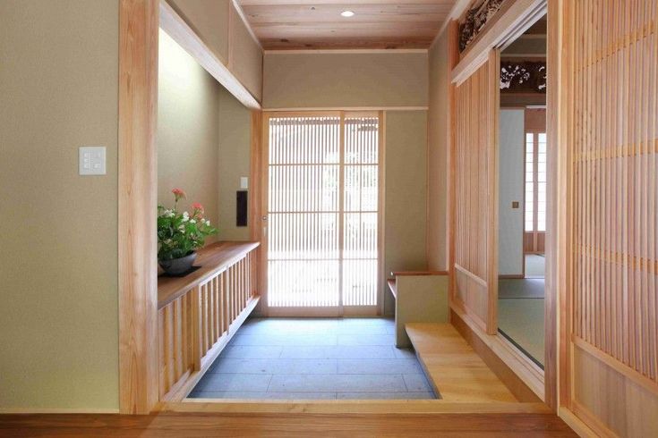 an empty hallway with wood paneling and sliding doors