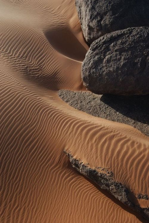 some rocks and sand in the desert