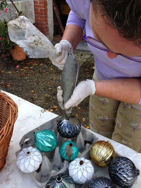 a man in white gloves and some ornaments on a table